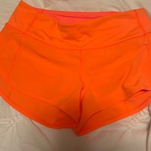 HIGHLIGHTER ORANGE LULULEMON SHORTS